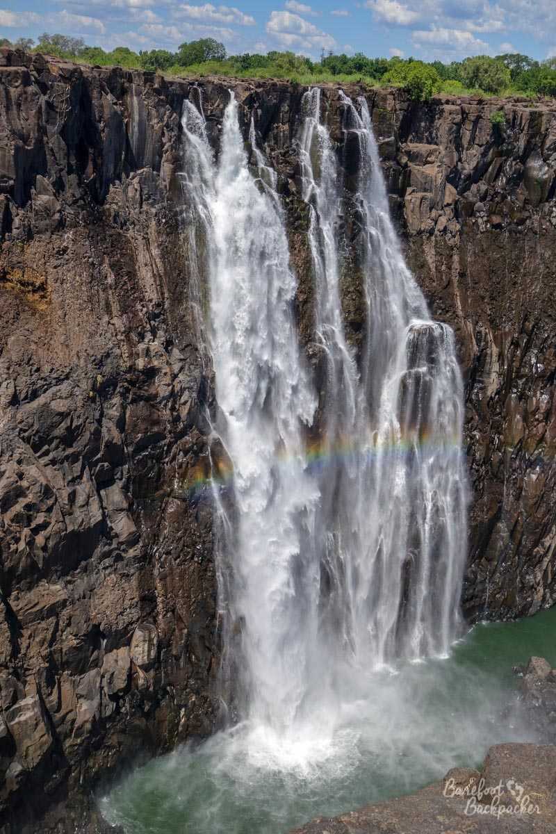The Rainbow Falls at Victoria Falls; there's a rainbow effect often visible across the water as it falls