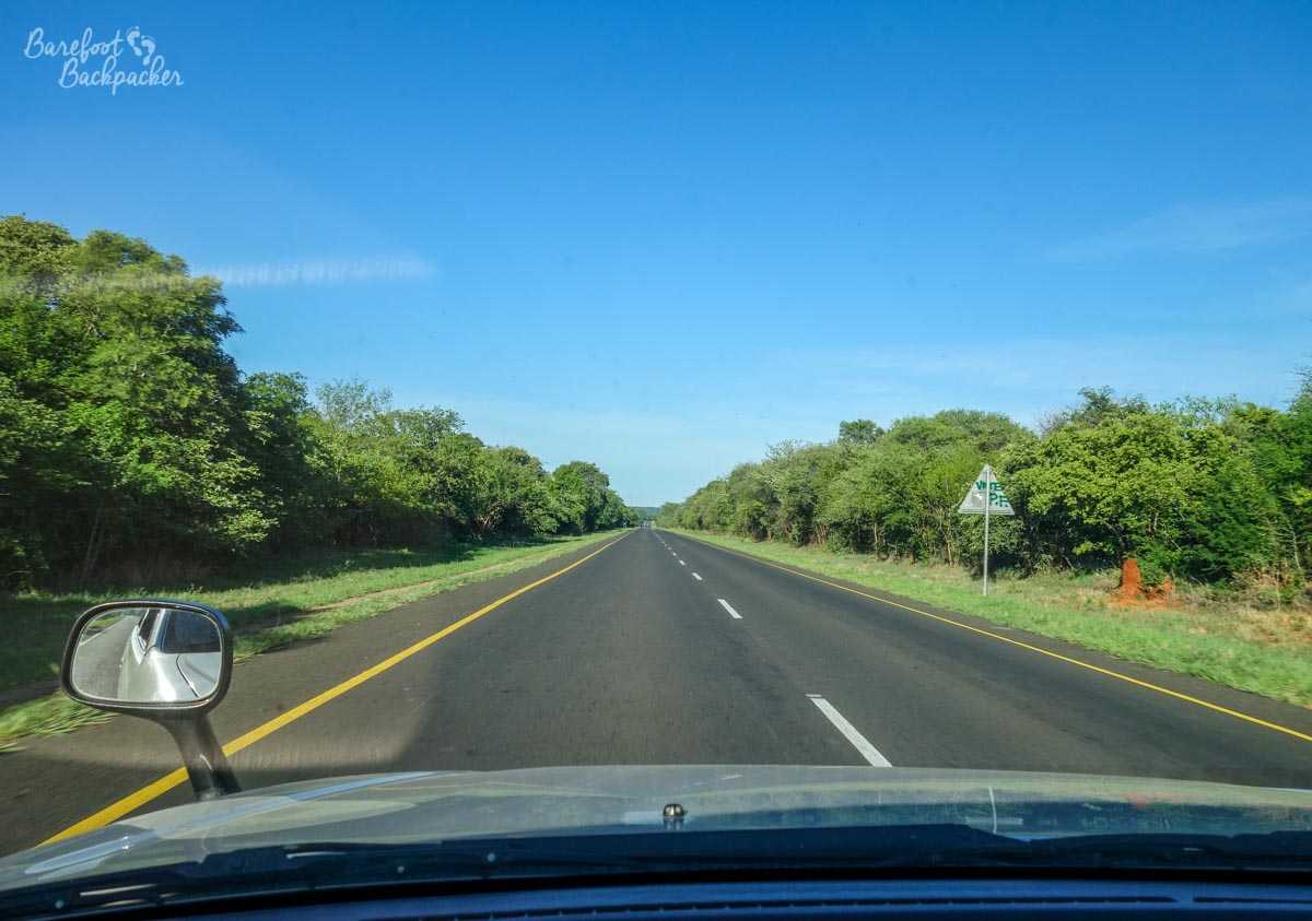 The Zambian countryside, New Years Day, on the way to Botswana. Beautiful clear blue skies and tree-lined road