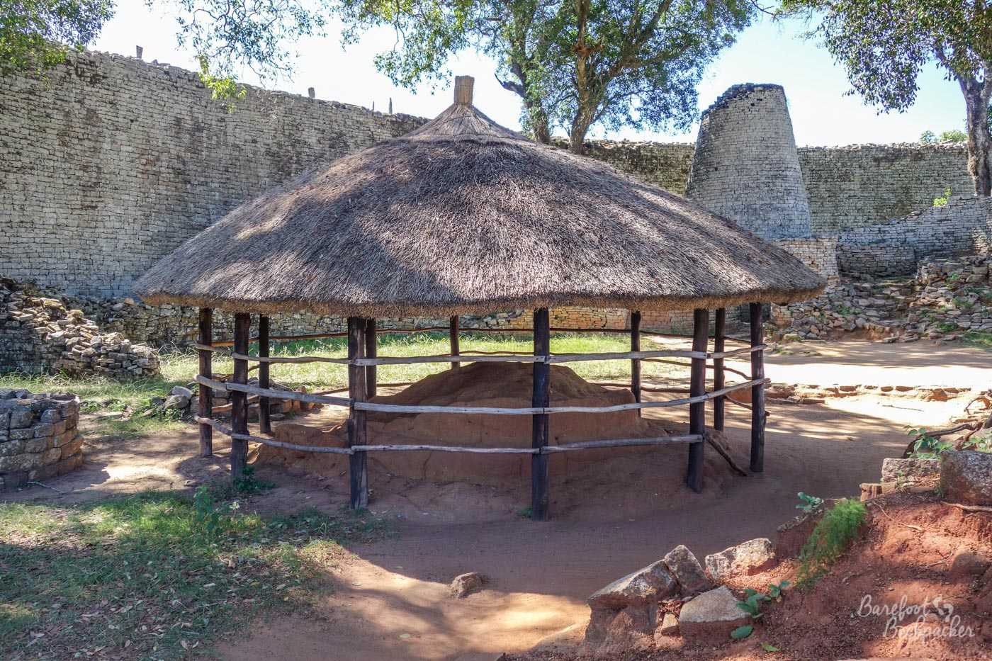Stone ruins in the Great Enclosure complex at Great Zimbabwe. A meeting or heating rondavel in the foreground, and the large conical tower behind