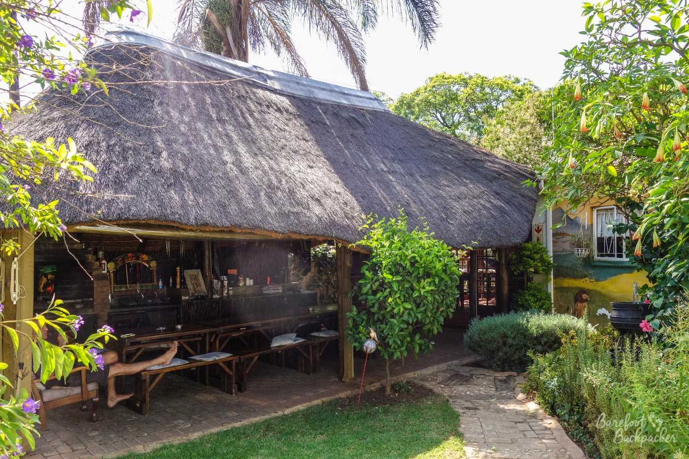 Thatched open-sided hut used as the outdoor dining area and braai in the Pretoria hostel.