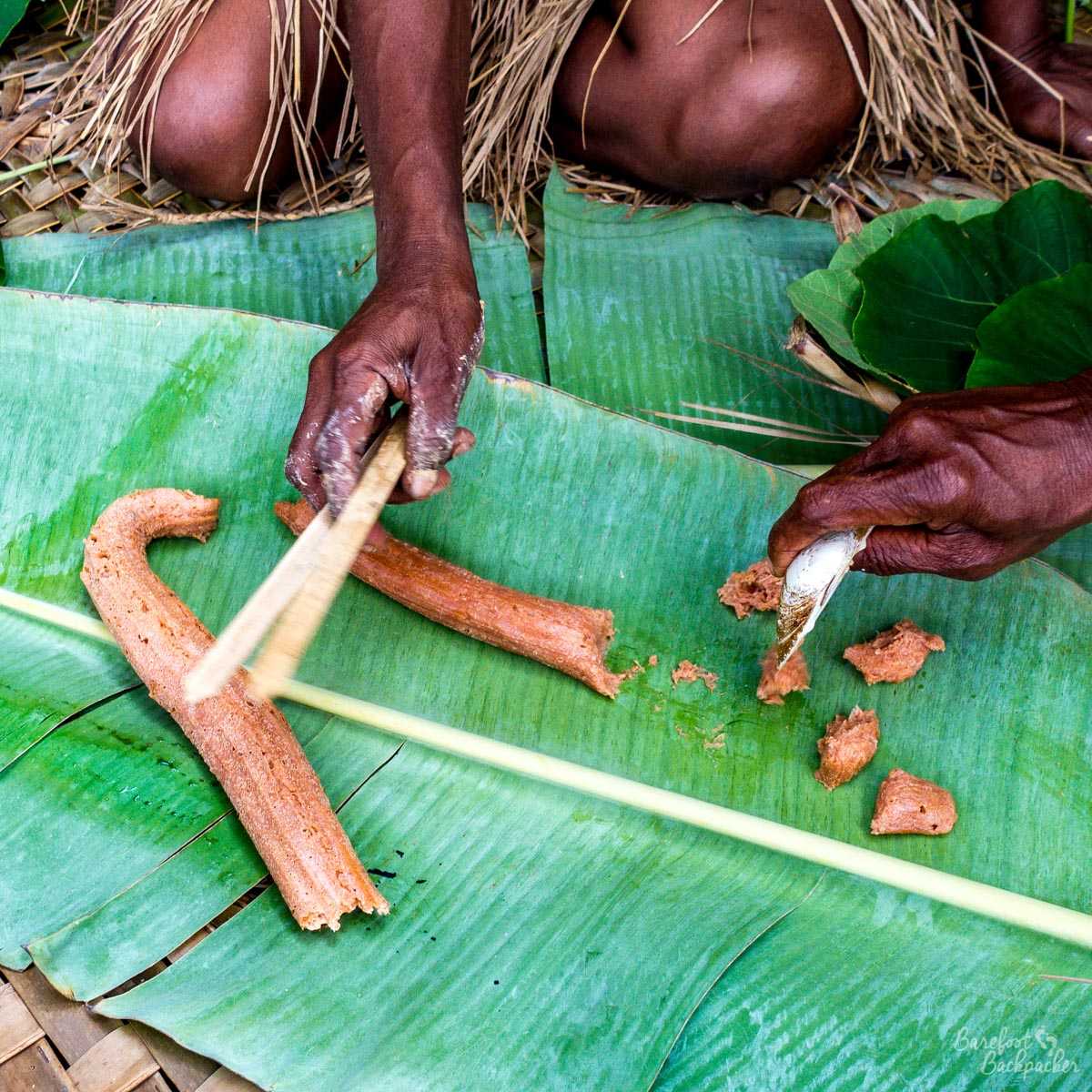A tribeswoman making laplap.