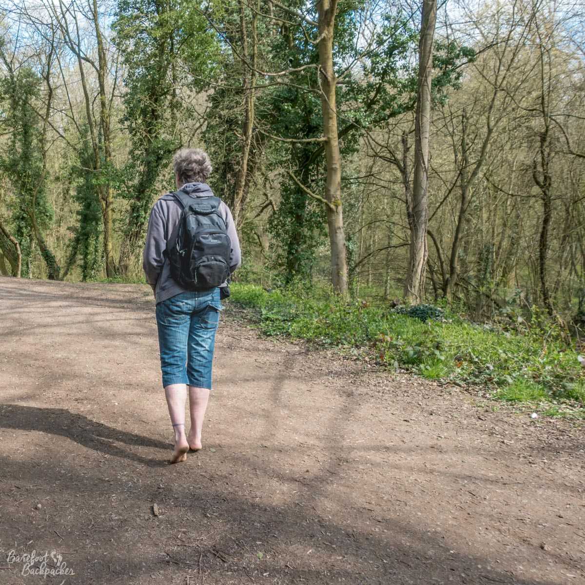 An image of me, walking out of shot in Portland Park - the woods in my hometown.