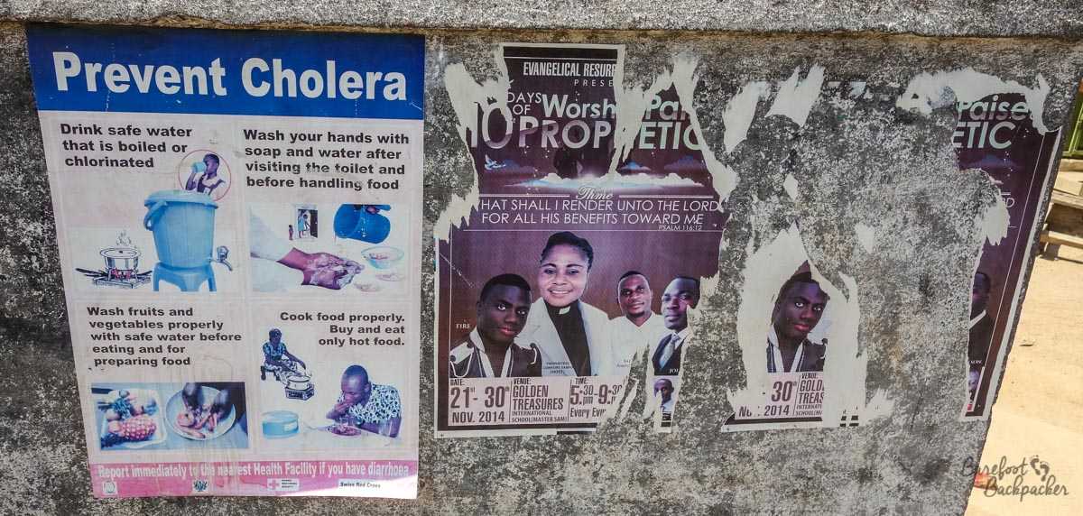 Posters in Cape Coast, Ghana, public health next to a religious advert