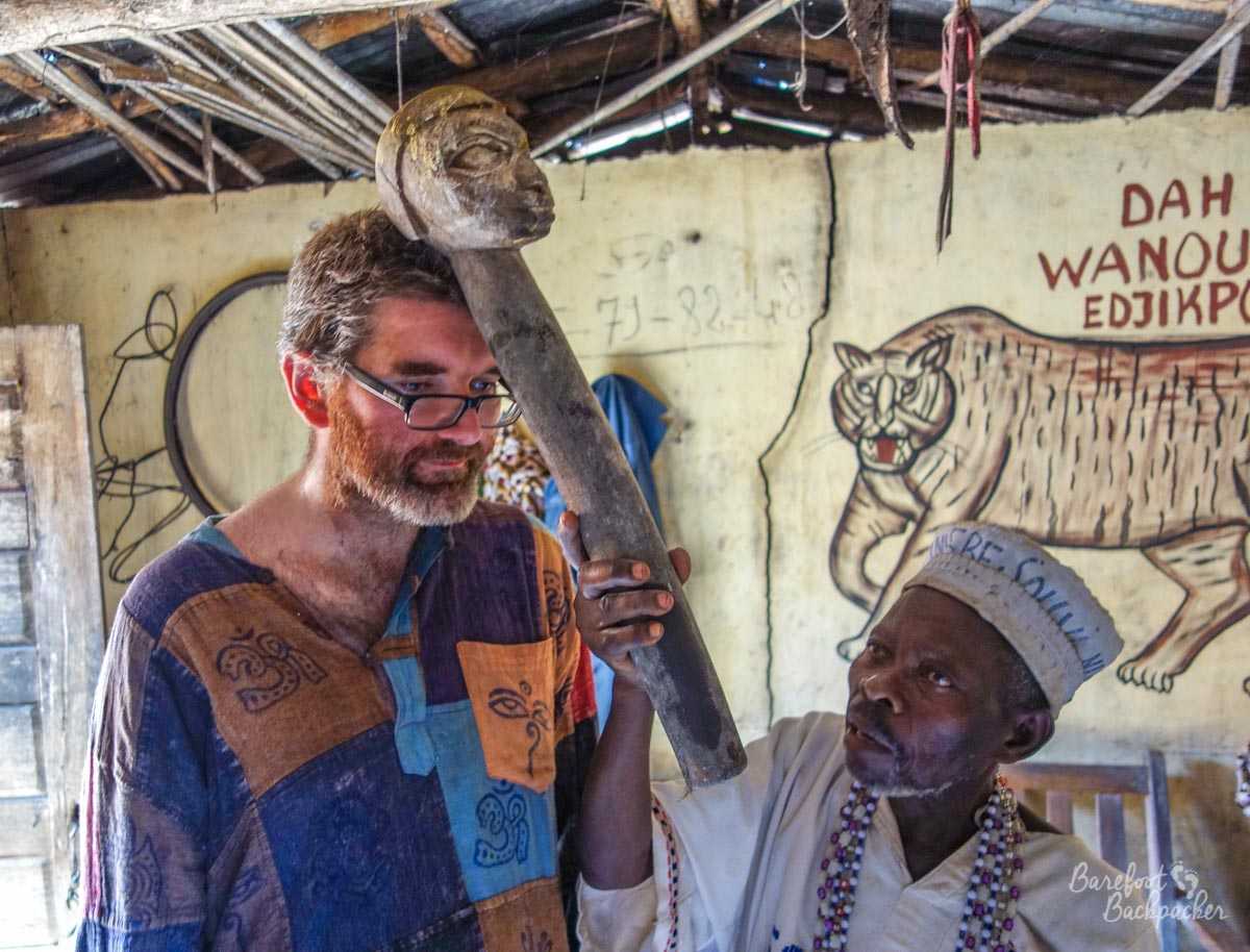 Partway through a Vodun ceremony – the Barefoot Backpacker is having his head tapped with a stone totem by the Vodun priest.