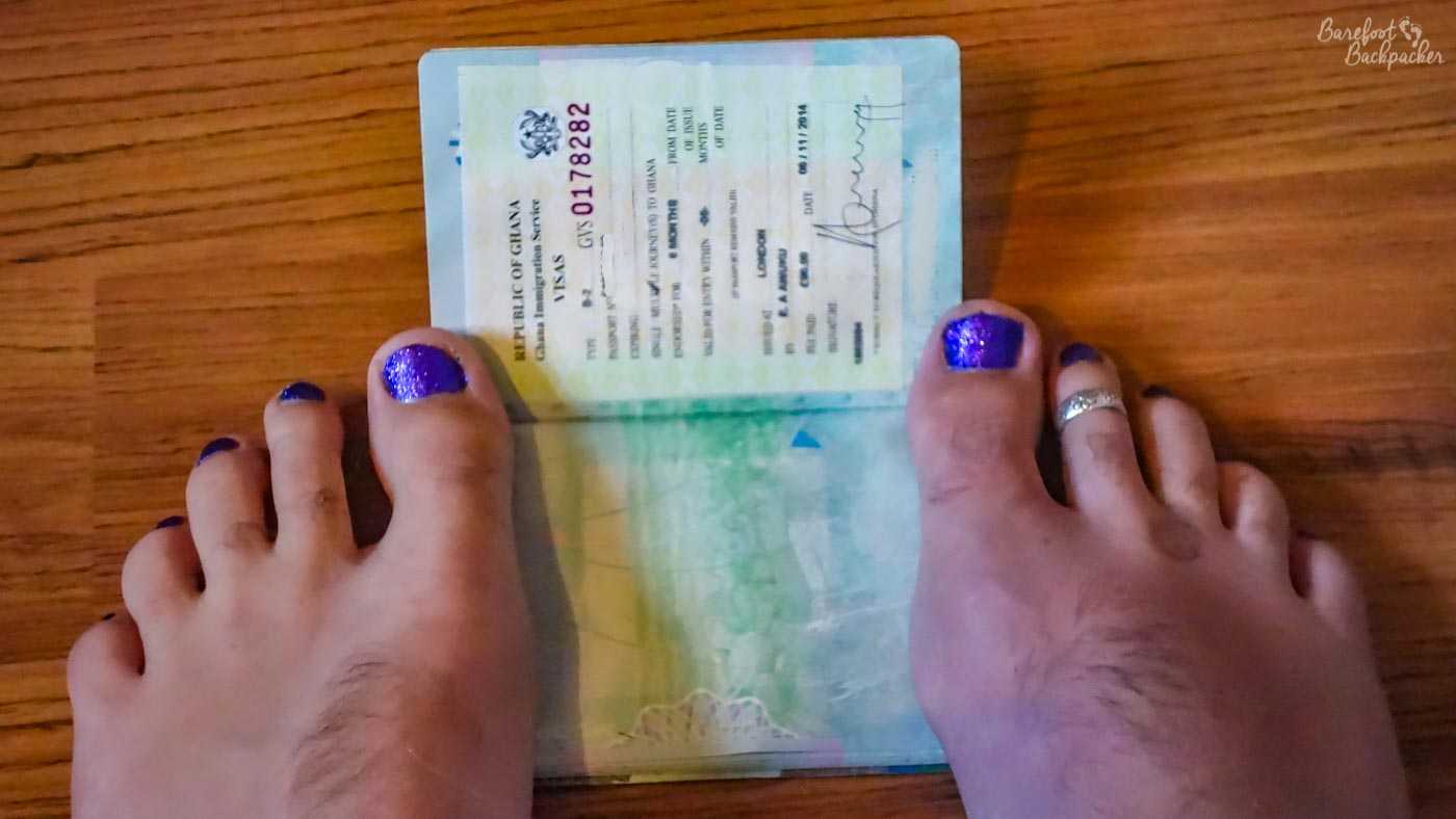 My purple-painted toes laid on the open page of my passport, wherein is stuck my visa for Ghana - a white slice of paper with all manner of interesting details printed upon it.
