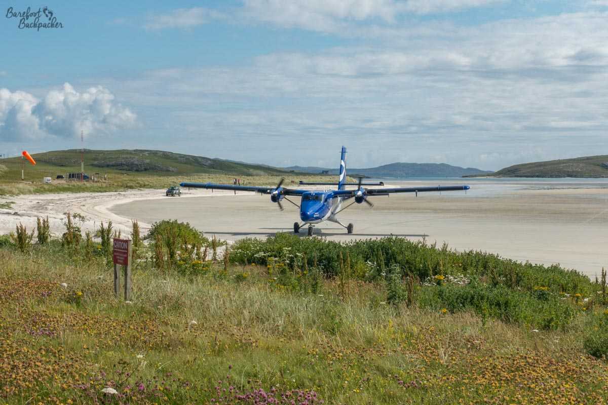 A small aeroplane at Barra Airport, manoeuvring along the sand.
