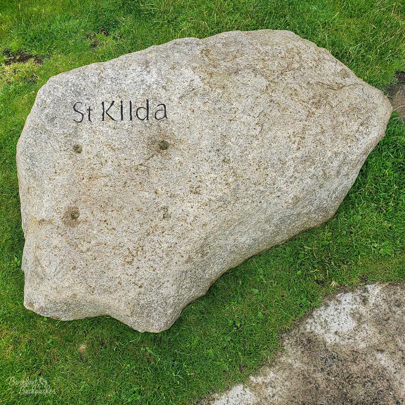The St Kilda name on a rock in the grass, near the harbour at Hirta.