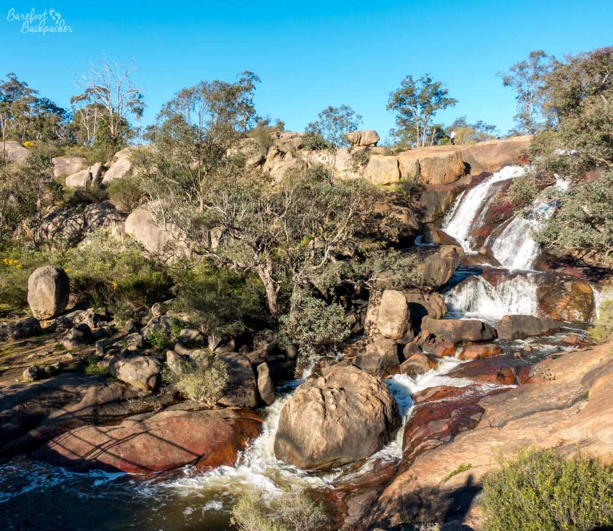 Small cascade of water over large boulders in John Forrest National Park.