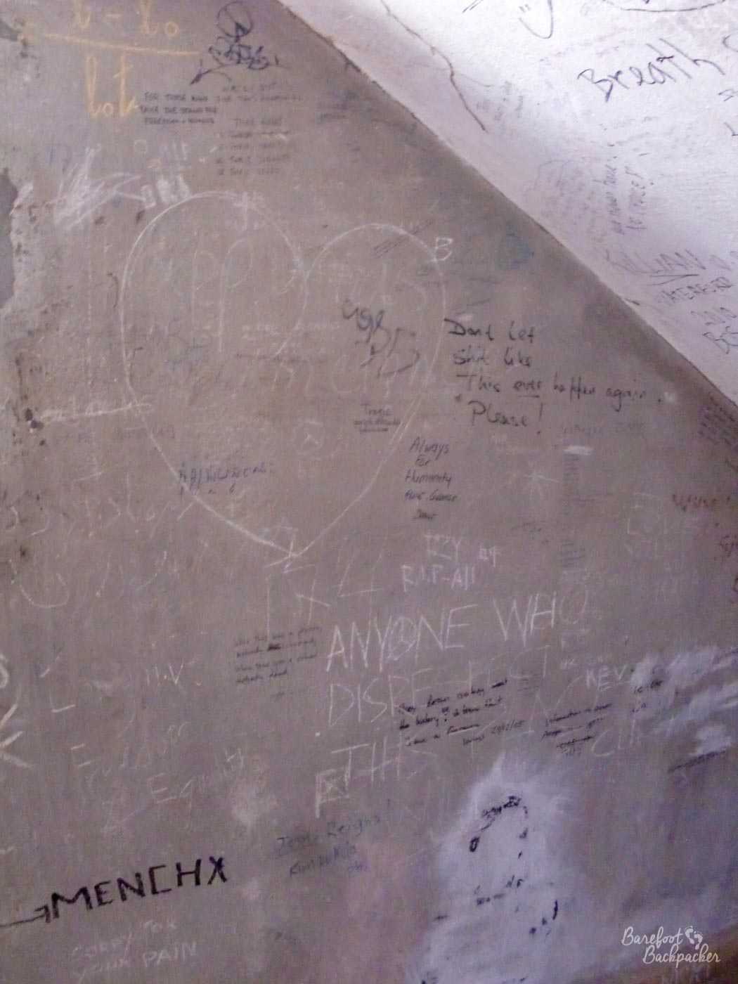 A wall inside one of the cells/rooms in Tuol Sleng. It has been written on by both locals and tourists, and all the phrases – mostly indistinct – are of the feel of 'this should never happen again' and 'sorry for your pain'.