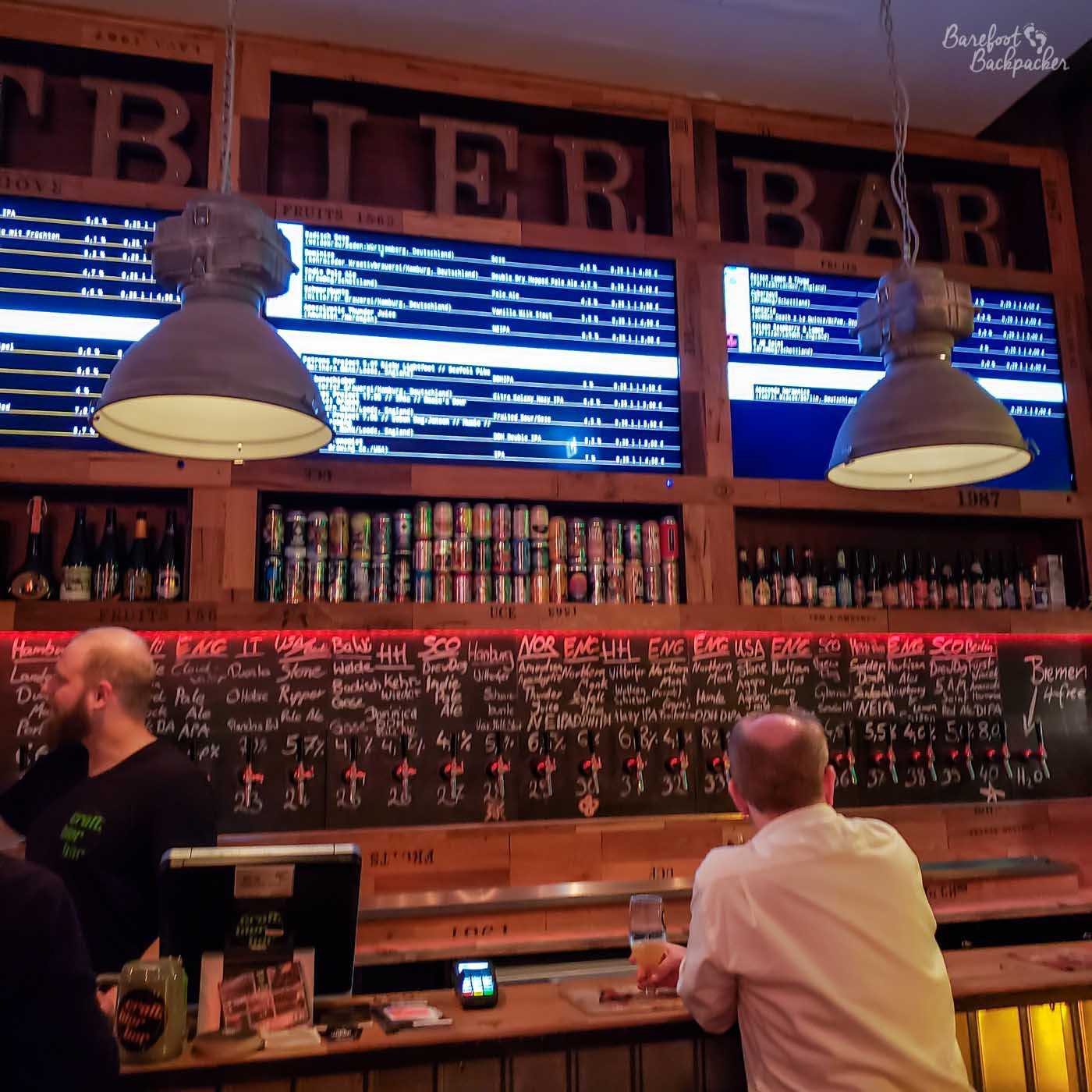 A picture taken inside a craft beer bar in Bremen, northern Germany. There's a lot of beers for sale from taps behind the bar, but most of them come from abroad, including Norway, England, Scotland, and the USA. There are a couple of local beers from Bremen and Hamburg, but relatively few.