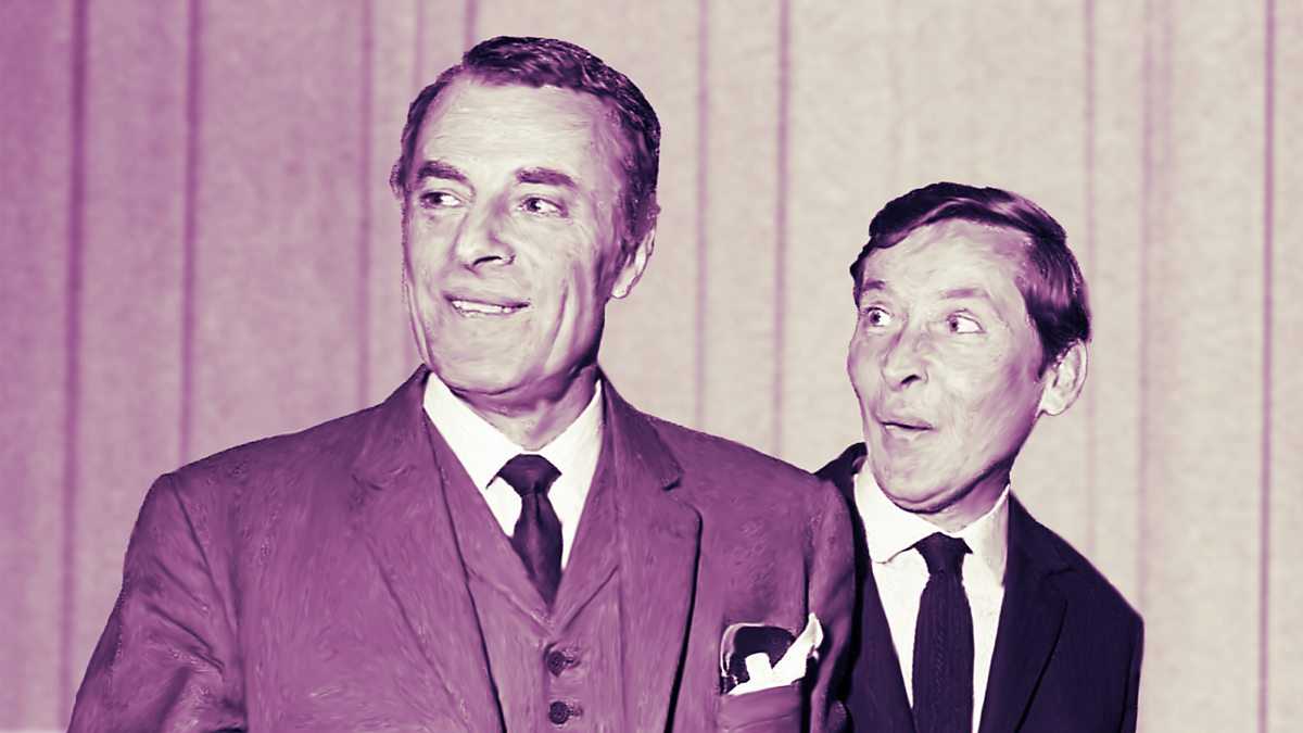 An image of Hugh Paddick and Kenneth Williams in character as Julian and Sandy. The image was taken in the 60s and consequently both men are dressed in suits and ties, and have regulation short haircuts. Hugh is even wearing a waistcoat.