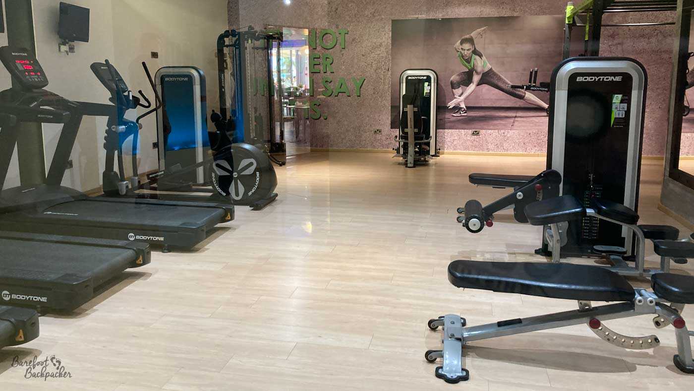 Overview of the multi-gym. There's a series of treadmills and other meep-fit equipment around the walls.