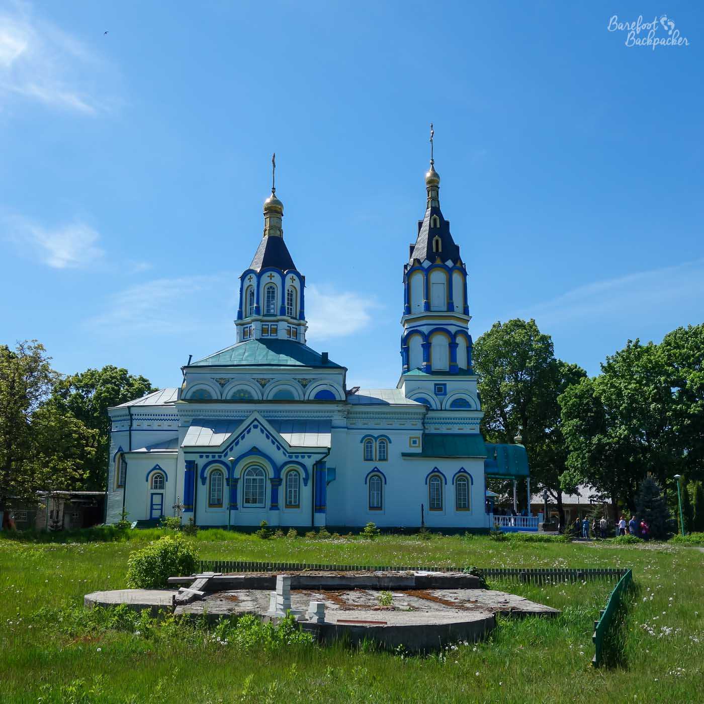 View of St Elijah's church, Chernobyl. It's a very typical Orthodox structure in design and colour, being mostly blue with a series of small rounded windows and two towers which terminate at a conal point.