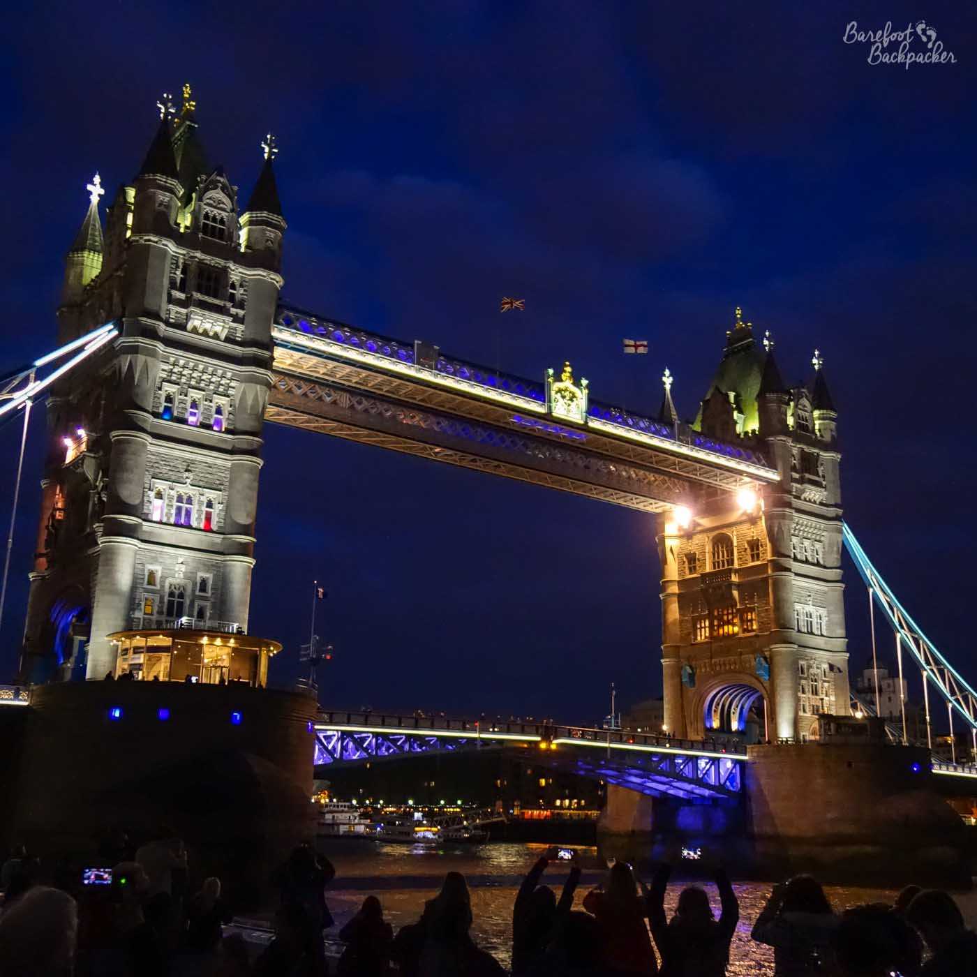 A picture of Tower Bridge in London, lit up with lots of lighting.