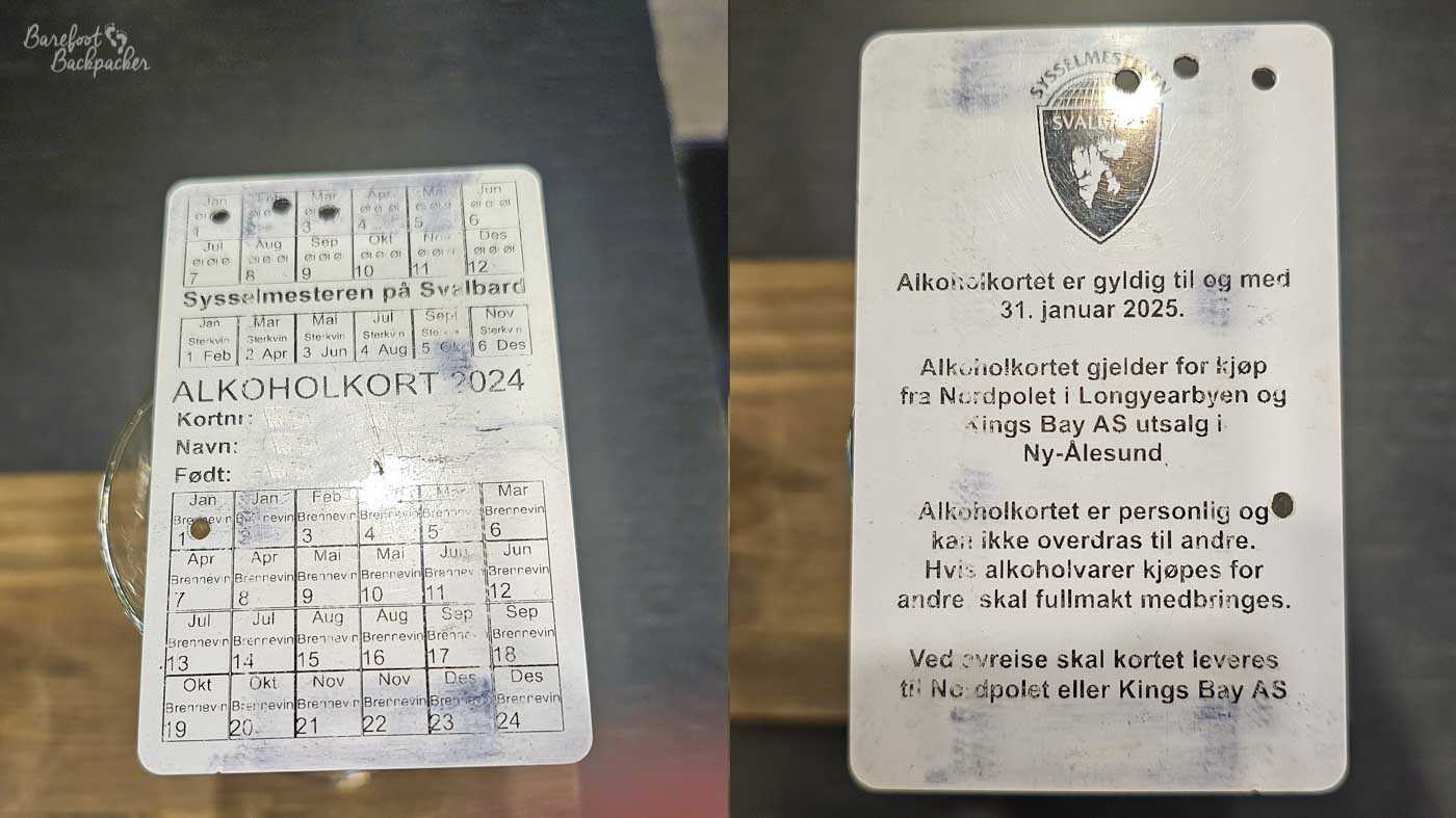 Two sides of a worn Svalbard alcohol purchase card displayed side by side, showing stamped monthly quotas and Norwegian text explaining its rules and validity. The scuffed surface and official markings highlight the unusual system regulating alcohol sales in this remote Arctic settlement.