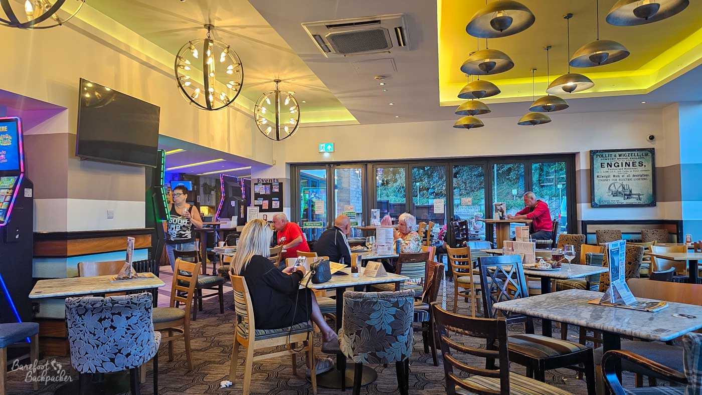 The spacious main room has the feel of a modern brewery tap, with high ceilings, contemporary pendant lighting and a mixture of wooden tables and upholstered chairs. Large windows look out towards the beer garden while customers enjoy meals and drinks throughout the open-plan space. Bright décor and generous seating give the venue a relaxed, family-friendly atmosphere without losing its pub character.